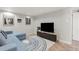 Cozy basement with recessed lighting, blue sofa and modern entertainment center with tile flooring at 840 S Gaylord St, Denver, CO 80209