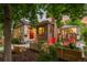 Charming brick home featuring a welcoming front entrance, complemented by colorful planters and a cozy outdoor seating area at 840 S Gaylord St, Denver, CO 80209