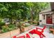 Inviting front yard with beautiful flower planters, walkway and red outdoor furniture at 840 S Gaylord St, Denver, CO 80209