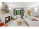 Elegant living room features a fireplace and large window with natural light at 840 S Gaylord St, Denver, CO 80209