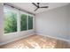 Well-lit bedroom offers generous sunlight, hardwood floors, and a ceiling fan at 2831 W 25Th Ave # 3, Denver, CO 80211