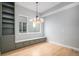 Bright dining area with custom built-in seating, storage, modern lighting and hardwood floors at 2831 W 25Th Ave # 3, Denver, CO 80211