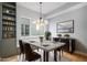 Elegant dining room with modern lighting, sleek furniture, and built-in shelving at 2831 W 25Th Ave # 3, Denver, CO 80211