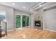Bright living room features a modern fireplace, hardwood floors, and large windows showcasing the green outdoors at 2831 W 25Th Ave # 3, Denver, CO 80211
