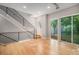 Bright living room features modern staircase, hardwood floors, and large windows with a view of the outdoors at 2831 W 25Th Ave # 3, Denver, CO 80211