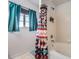 Clean bathroom with tub, shower and patterned curtain at 4460 S Jebel Ln, Centennial, CO 80015