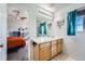 Bathroom with double vanity and view into bedroom at 4460 S Jebel Ln, Centennial, CO 80015