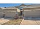 Townhouse exterior with two-car garage and landscaped front yard at 4460 S Jebel Ln, Centennial, CO 80015