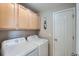 Bright laundry room with washer, dryer, and ample overhead storage at 4460 S Jebel Ln, Centennial, CO 80015