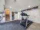 Finished basement features a rec area and gym space with carpet and padded floor at 20592 E Lake Ave, Centennial, CO 80016