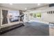 Finished basement features a rec area and gym space with carpet and padded floor at 20592 E Lake Ave, Centennial, CO 80016