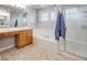 Bathroom with tiled floor, soaking tub with tile surround and glass door shower at 20592 E Lake Ave, Centennial, CO 80016
