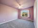 This bedroom has carpet, a ceiling fan, and natural light from the bright window at 20592 E Lake Ave, Centennial, CO 80016