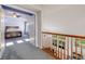 View from upper landing to bedroom with carpet and natural light at 20592 E Lake Ave, Centennial, CO 80016