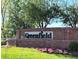 Elegant brick community sign for Greenfield set against a backdrop of lush greenery and flowers at 20592 E Lake Ave, Centennial, CO 80016
