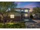 Inviting two-story home with warm lighting and a charming front porch at 20592 E Lake Ave, Centennial, CO 80016