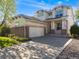 Attractive two-story home featuring a brick facade, a two-car garage, and a cozy front porch at 20592 E Lake Ave, Centennial, CO 80016