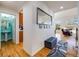 Spacious foyer with wood floors, a mirror, and access to the living room, bathroom and kitchen at 20592 E Lake Ave, Centennial, CO 80016