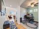 Comfortable home office featuring a ceiling fan, neutral walls, and a view of the living room at 20592 E Lake Ave, Centennial, CO 80016