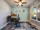Well-lit home office featuring a large window, ceiling fan, and a comfortable workspace at 20592 E Lake Ave, Centennial, CO 80016