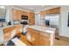 Charming kitchen with wooden cabinets, stainless steel appliances, and hardwood floors at 20592 E Lake Ave, Centennial, CO 80016
