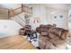 Well-lit living room features hardwood floors, a cozy seating area, and staircase to the second floor at 20592 E Lake Ave, Centennial, CO 80016
