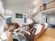Bright living room with tall ceilings, modern decor, and staircase to the second floor at 20592 E Lake Ave, Centennial, CO 80016