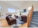 Bright living room with a fireplace, large windows, and comfortable leather seating at 20592 E Lake Ave, Centennial, CO 80016