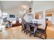 Open living space with dining area, stairs, and a glimpse of the kitchen with hardwood floors at 20592 E Lake Ave, Centennial, CO 80016