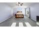 This main bedroom has carpet, a ceiling fan, and natural light from the set of transom windows at 20592 E Lake Ave, Centennial, CO 80016