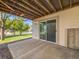 Rear patio with sliding door access to the home and a concrete surface with a small rock border at 20592 E Lake Ave, Centennial, CO 80016