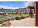 Spacious backyard with a stone patio, lush green lawn, and mountain views at 15314 W Baker Ave, Lakewood, CO 80228