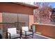 Outdoor balcony featuring modern chairs, privacy screen, and potted plants with neighborhood views at 15314 W Baker Ave, Lakewood, CO 80228