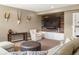 Inviting basement living area with a large television, stylish decor, and plenty of seating at 15314 W Baker Ave, Lakewood, CO 80228