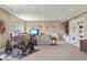 Finished basement featuring a home gym, entertainment area, and plenty of natural light at 15314 W Baker Ave, Lakewood, CO 80228