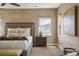 Serene bedroom featuring mountain views, textured wallpaper, large bed, and soft lighting at 15314 W Baker Ave, Lakewood, CO 80228