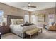 Inviting bedroom with neutral tones, large windows, a ceiling fan, and stylish decor at 15314 W Baker Ave, Lakewood, CO 80228