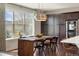 Bright dining room features a large window, wooden table, and dark wood cabinets at 15314 W Baker Ave, Lakewood, CO 80228
