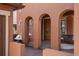 Arched entryway with wooden front door, flanked by seating areas with neutral cushions and pillows at 15314 W Baker Ave, Lakewood, CO 80228