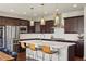 Stylish kitchen boasts stainless steel appliances, an island with seating, and pendant lighting at 15314 W Baker Ave, Lakewood, CO 80228