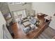 Overhead view of a living room with a stone fireplace, hardwood floors, and comfortable seating at 15314 W Baker Ave, Lakewood, CO 80228