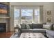 Comfortable living room boasts stone fireplace, large windows, and stunning mountain views at 15314 W Baker Ave, Lakewood, CO 80228