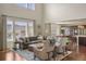Open-concept living room with hardwood floors, comfortable seating, and lots of natural light at 15314 W Baker Ave, Lakewood, CO 80228