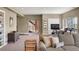 Cozy living room with a neutral color palette, comfortable sofa, and a walkout basement entrance at 15314 W Baker Ave, Lakewood, CO 80228