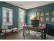 Bright office space featuring calming green paint, shuttered windows, and modern furnishings at 15314 W Baker Ave, Lakewood, CO 80228