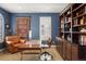 Inviting office boasts a cozy leather chair, built-in shelving, and ample desk space at 15314 W Baker Ave, Lakewood, CO 80228