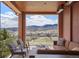 Relaxing outdoor patio featuring mountain views, comfortable seating, and stylish decor at 15314 W Baker Ave, Lakewood, CO 80228