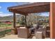 Charming outdoor patio featuring a pergola, comfortable seating, and scenic views of the neighborhood at 15314 W Baker Ave, Lakewood, CO 80228