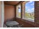 Relaxing patio with an iron table and chairs, framed by brick columns, offering pleasant neighborhood views at 15314 W Baker Ave, Lakewood, CO 80228