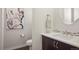 Chic powder room features modern fixtures, decorative mirror, and stylish artwork at 15314 W Baker Ave, Lakewood, CO 80228